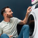 man-waiting-washing-machine-finish-its-program_23-2149117024